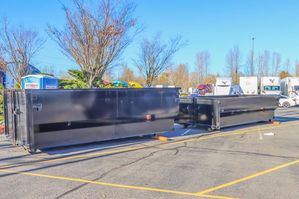 Professional dumpster rental service with roll-off container on residential driveway in Macclenny